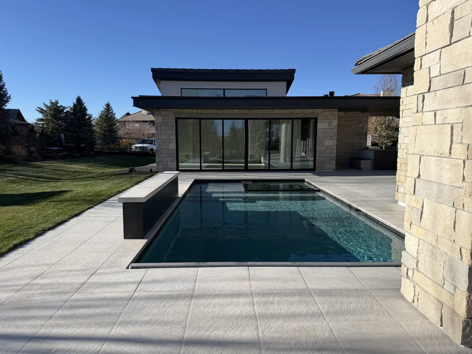 Completed stone terrace and pool at a Denver residence