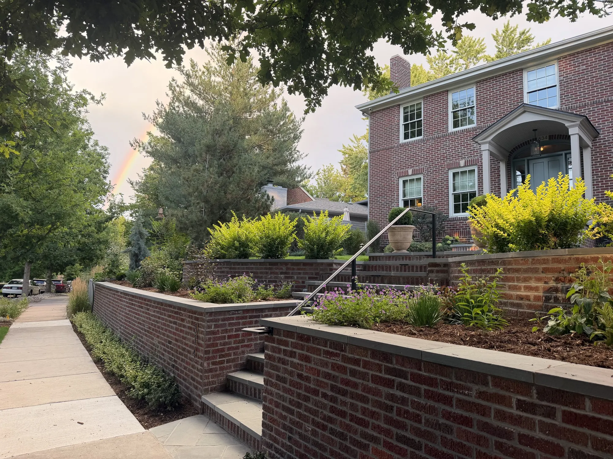 Terraced perennial beds against brick garden walls