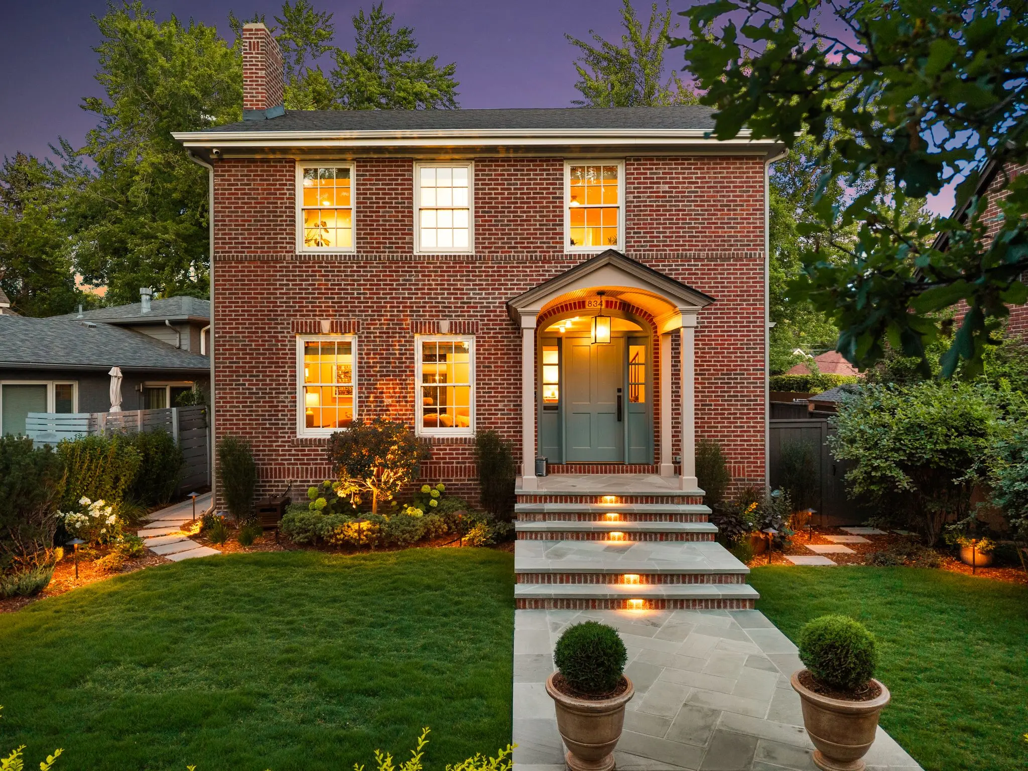 Illuminated entry walk and planting at twilight